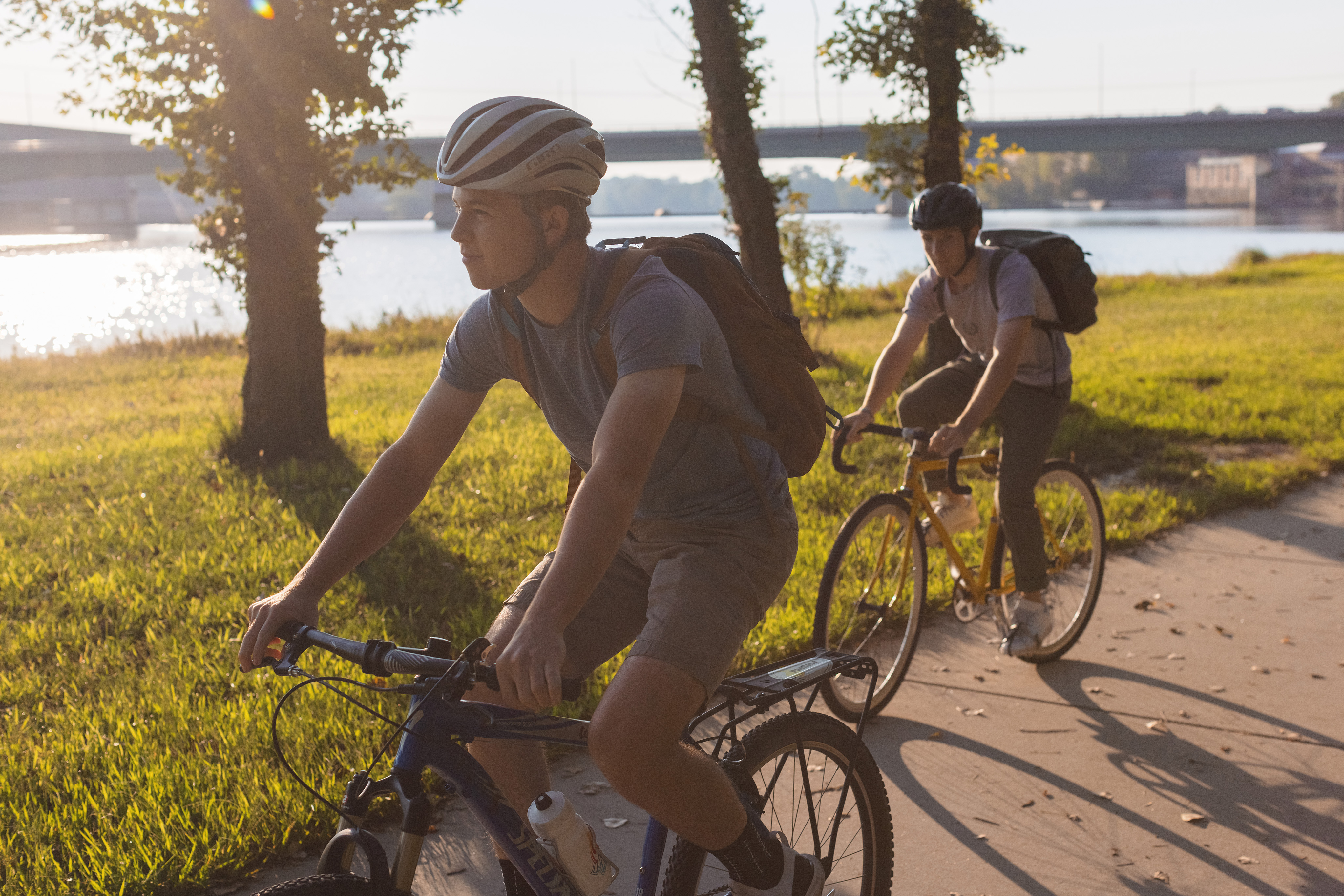 Two students use the Burcham Park bike path along the Kansas River in Lawrence