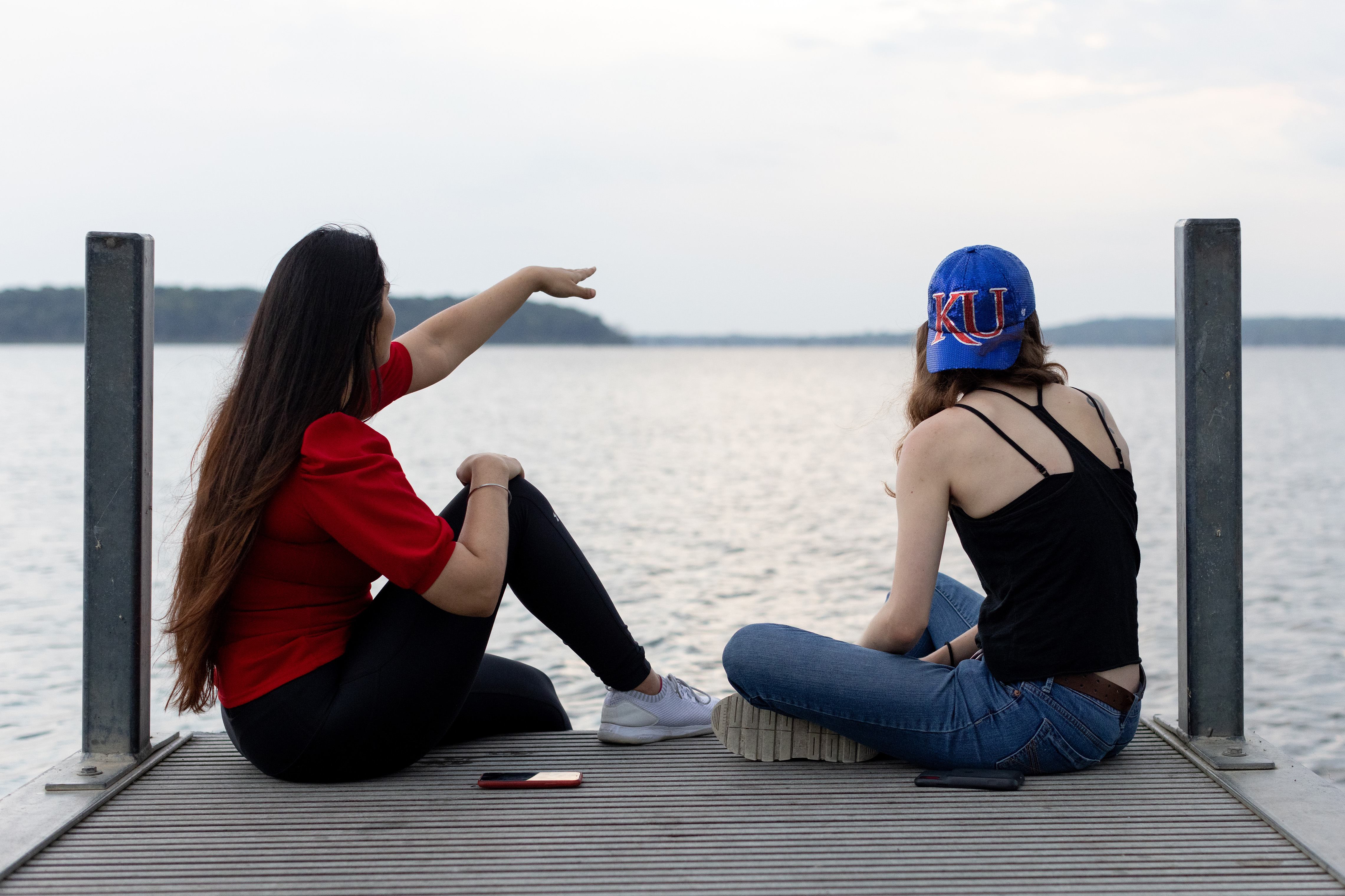 Students sit on a dock at Clinton Lake