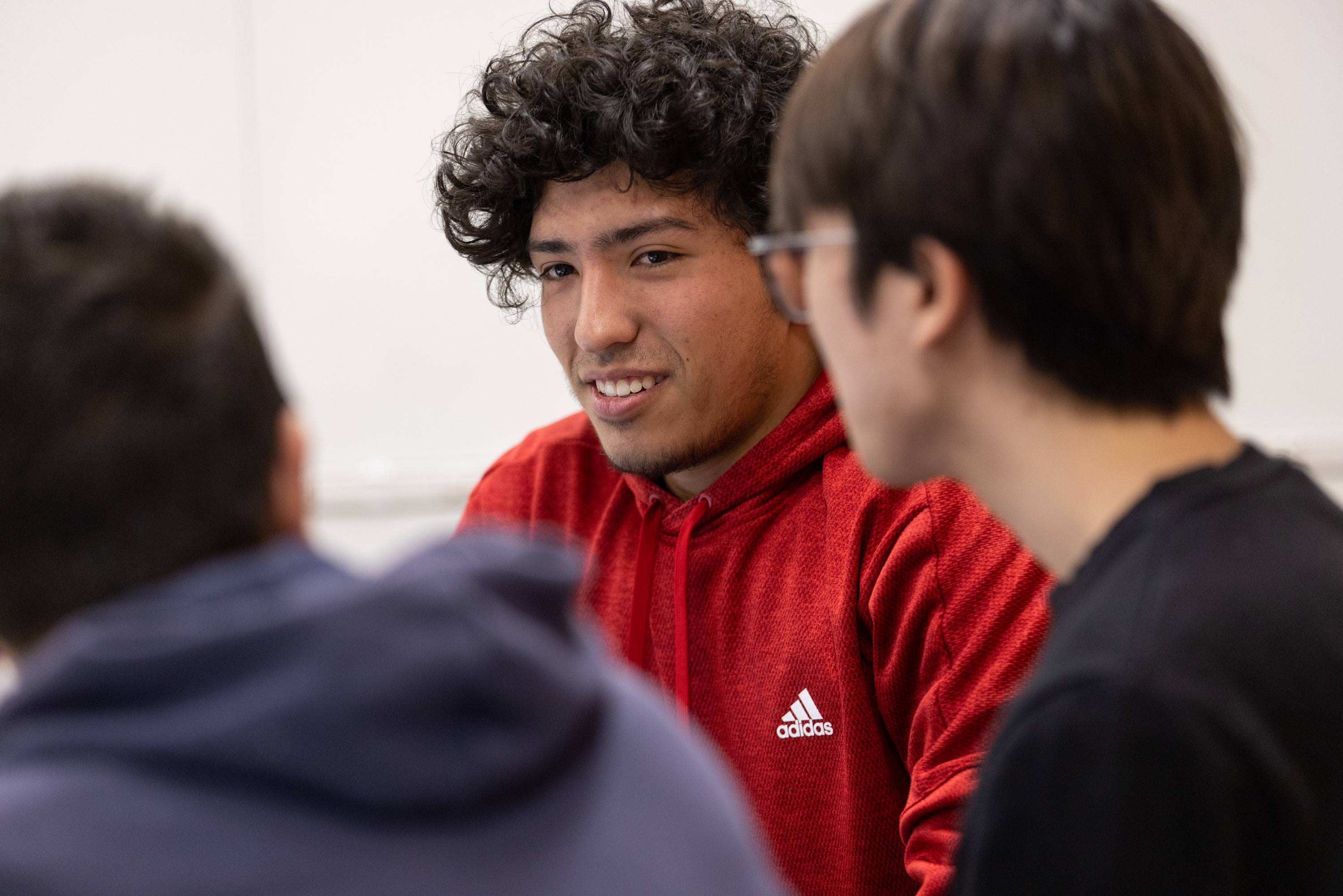 Three students disucussing at a table